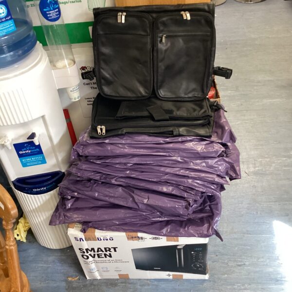 Large quantity of black leather bags