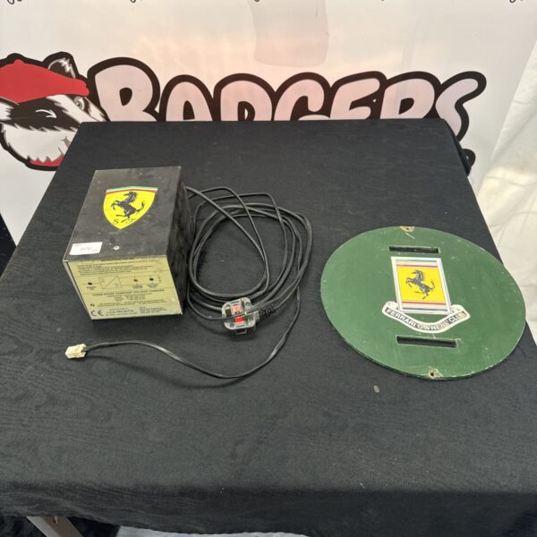 L C N projects trickle charger with wooden plaque displaying ferrari owners club sticker