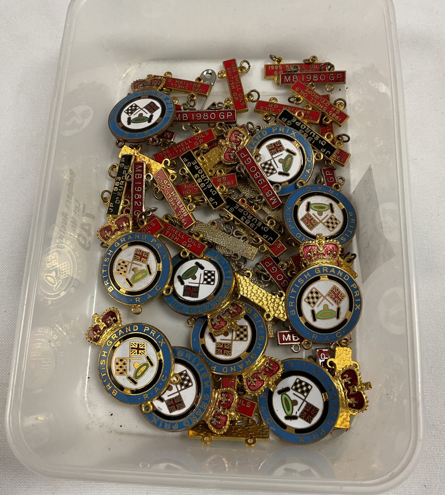 Tray of RAC British Grand Prix enamel pin badges with gp date bars