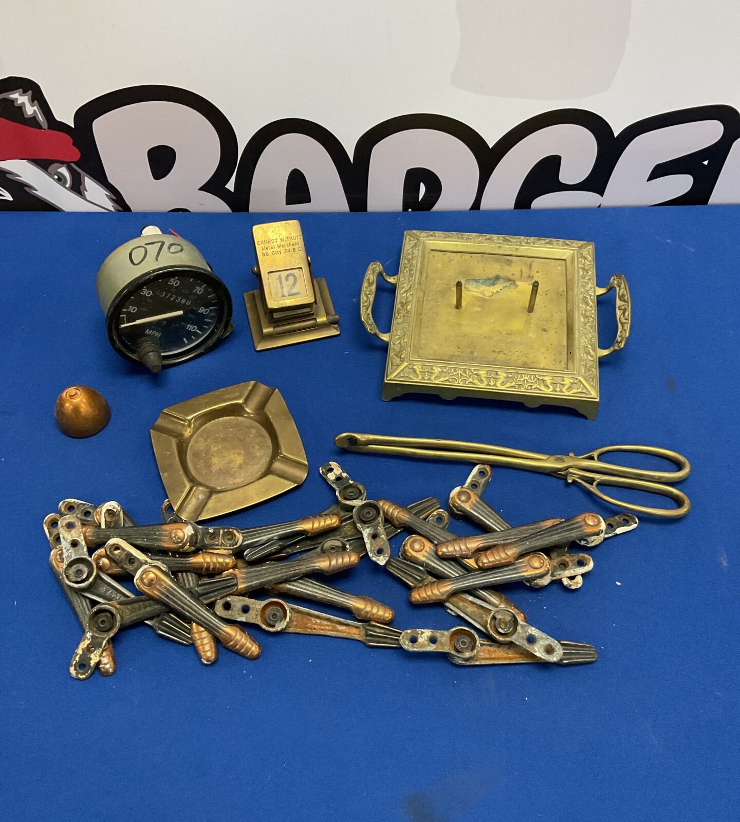 Box of metalware including day date calendar & car speedometer