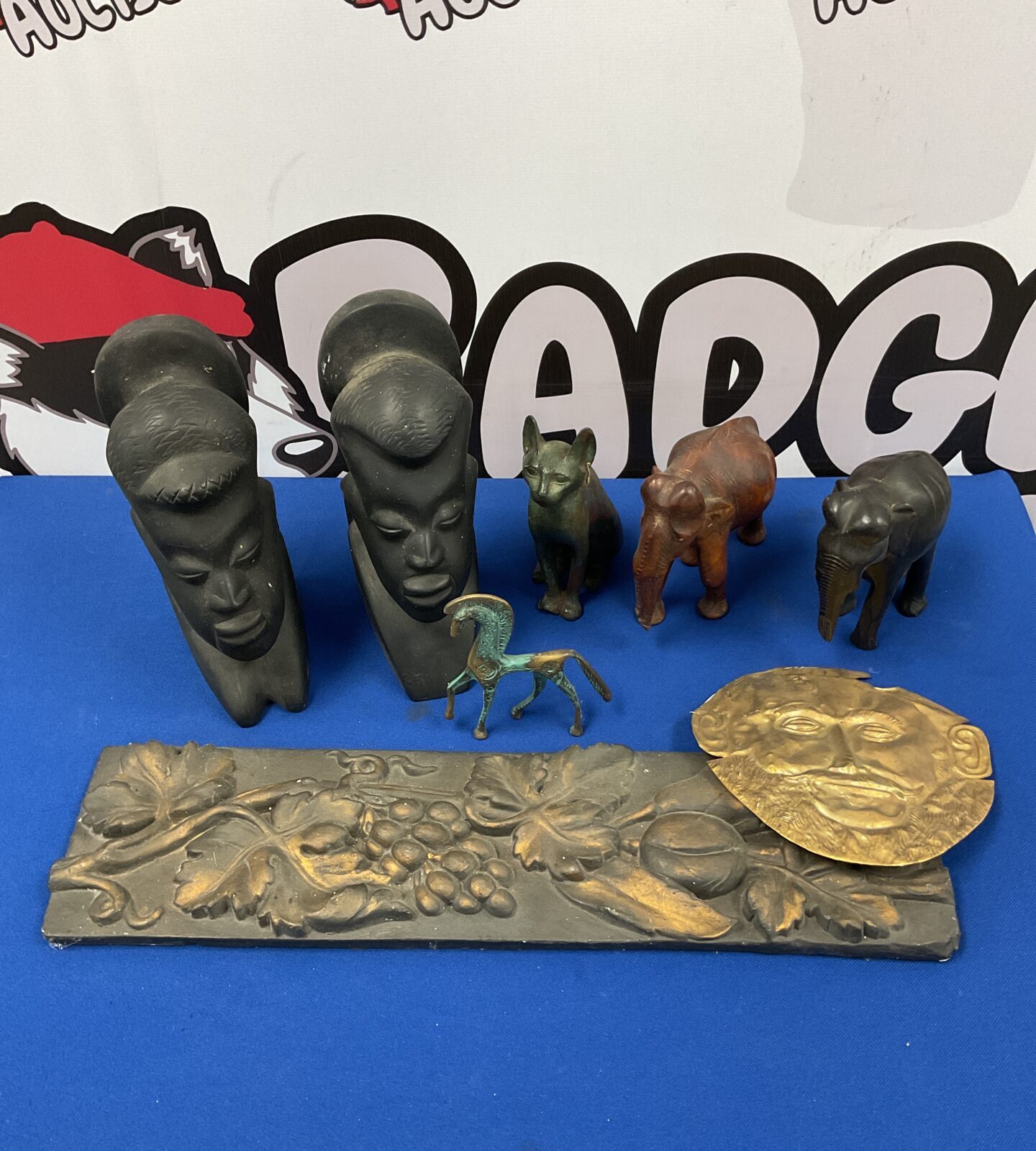 Pair of vintage carved wooden african busts with museum replica artifacts