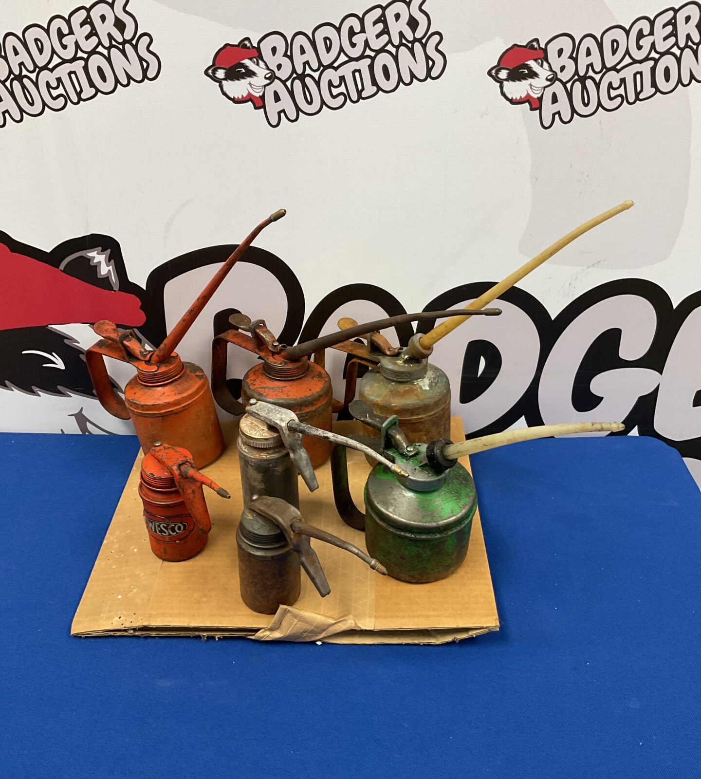 Collection of 7 vintage oil cans including wesco