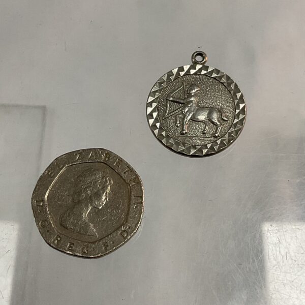 Silver Sagittarius zodiac pendant and British coin set.