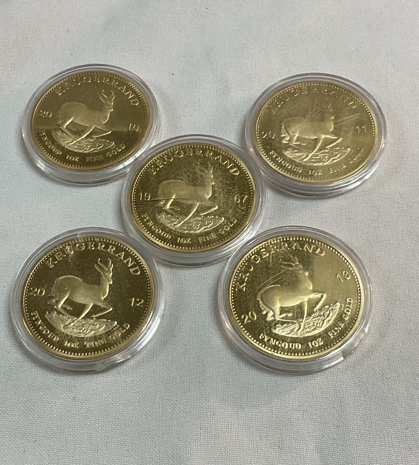 Five replica commemorative krugerands