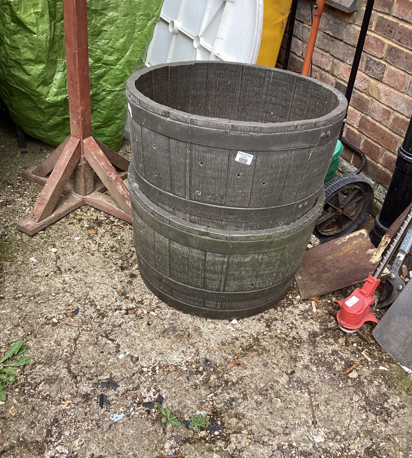 Two barrel style plastic garden planters