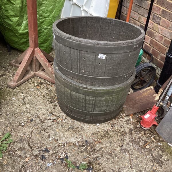 Two barrel style plastic garden planters