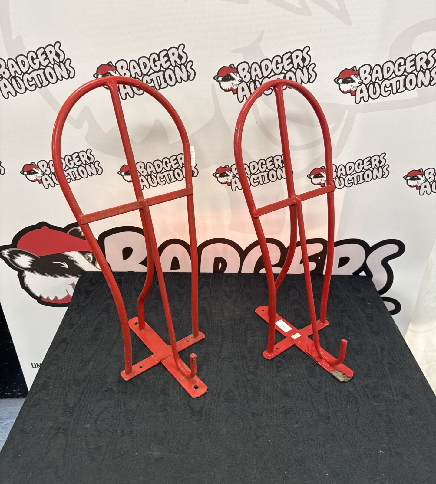 Two metal wall mounted horse saddle racks