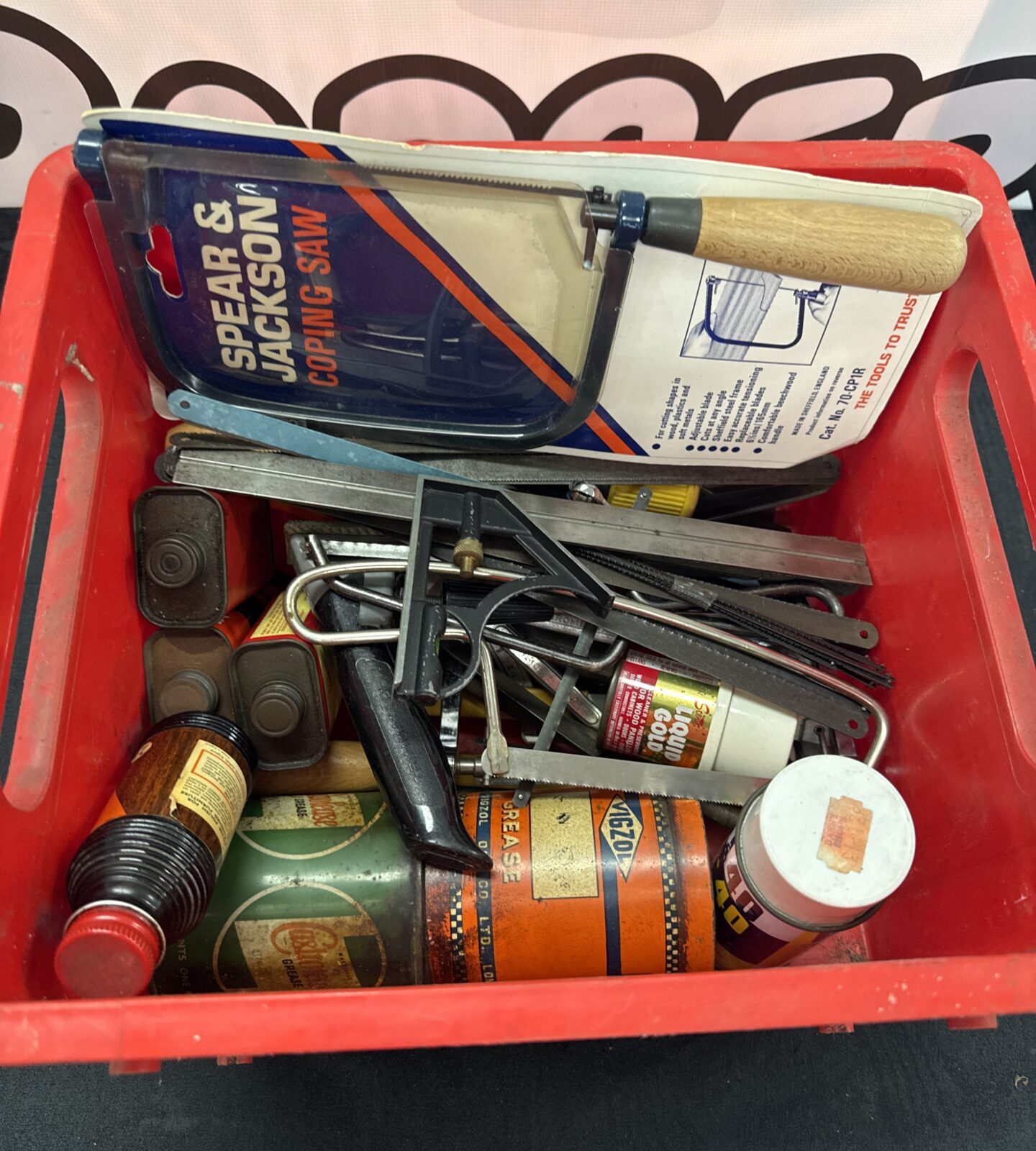 Box of mixed items inc vintage grease tins & new spear & Jackson coping saw
