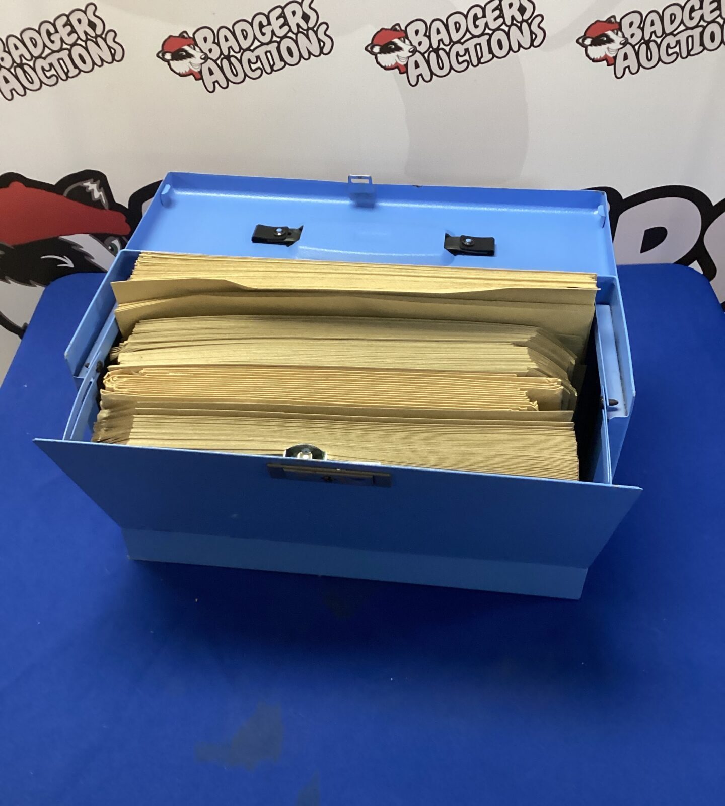 Metal filing box with brown envelopes inside