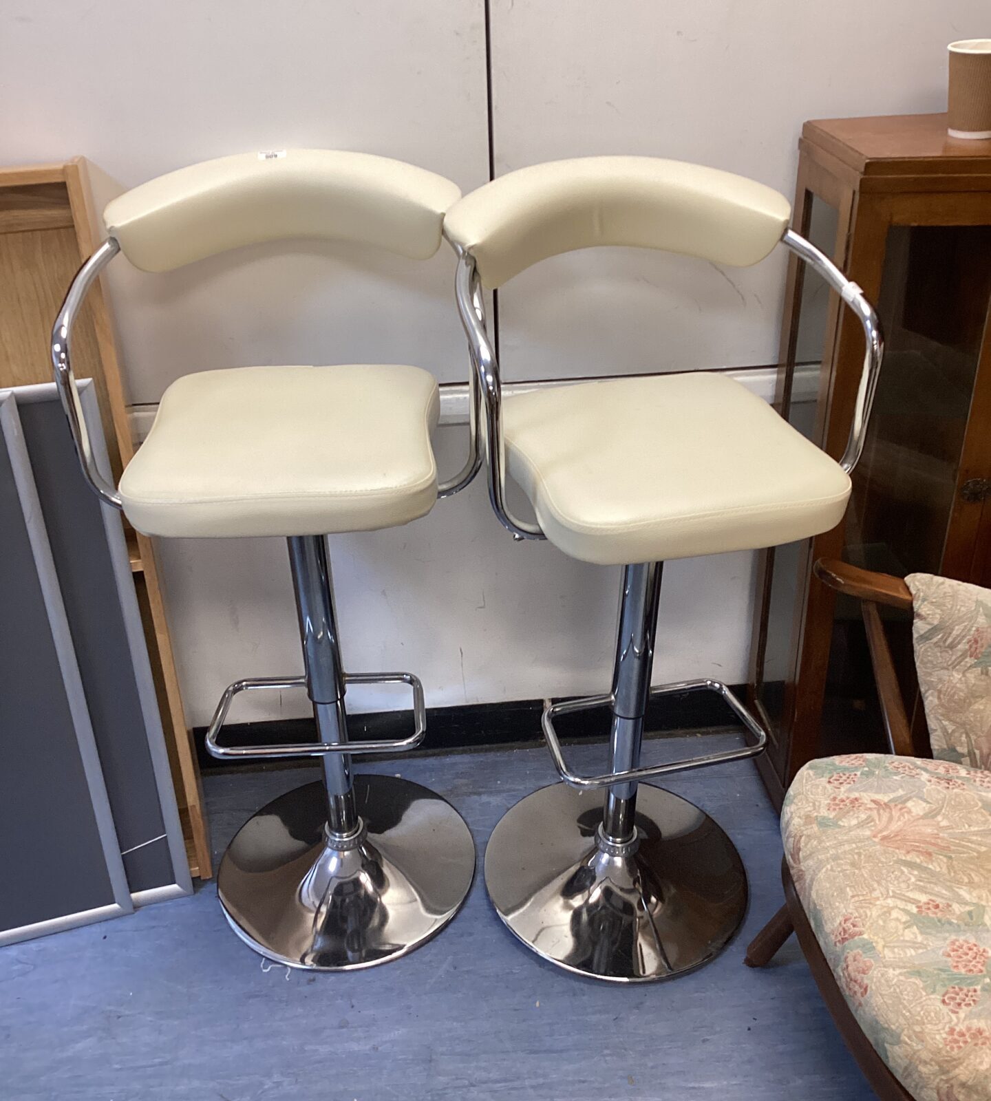 Two cream leather bar stools
