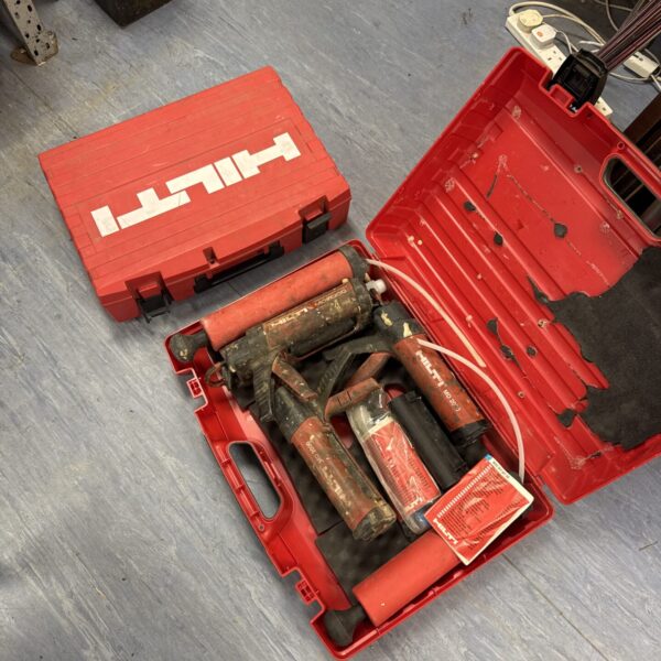 Selection of hilti tools inc md2000 sealant guns & an empty Hilti case