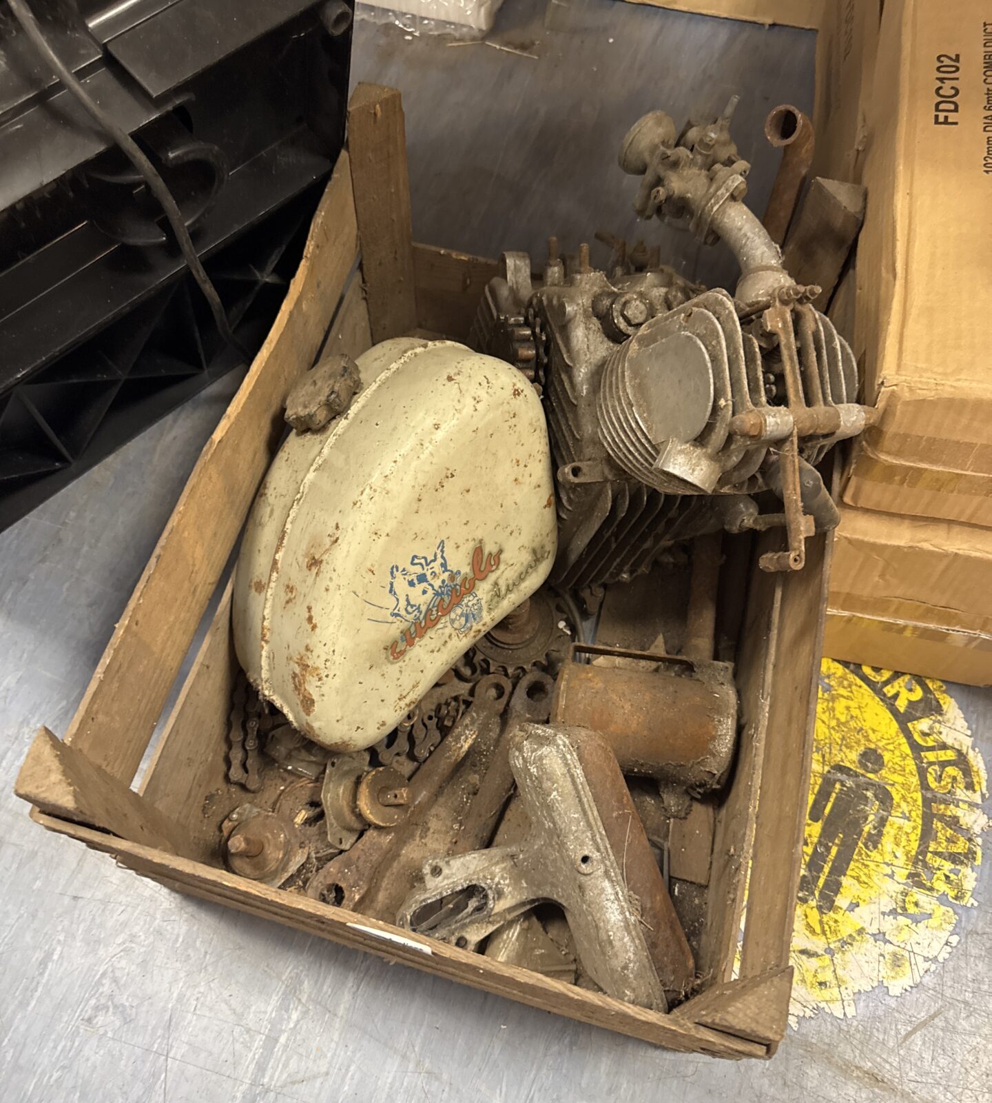 Tray of vintage bycycle conversion kit parts Inc ducati engine and cucciolo fuel tank and parts for conversion