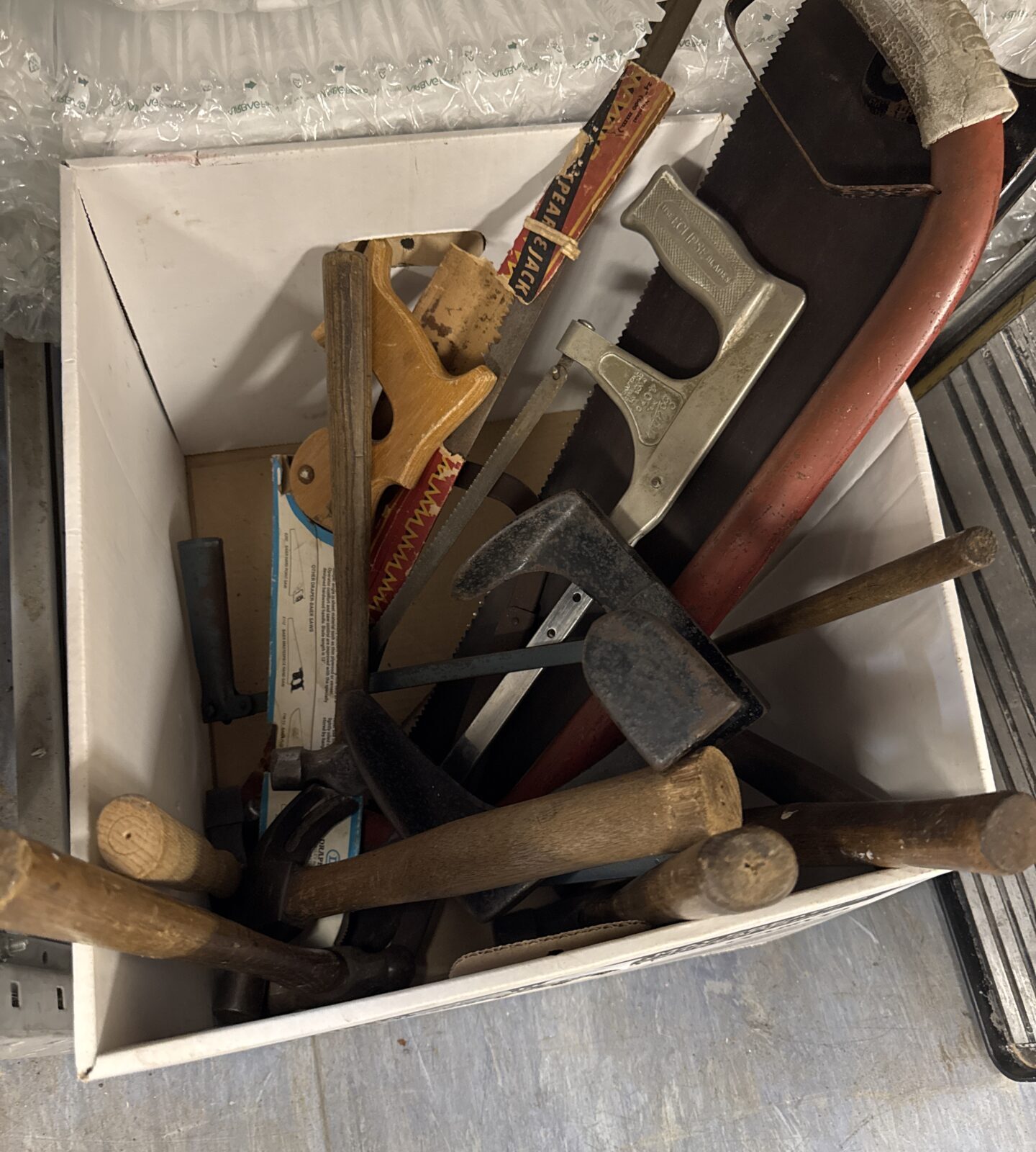 Box of assorted tools inc saws & others
