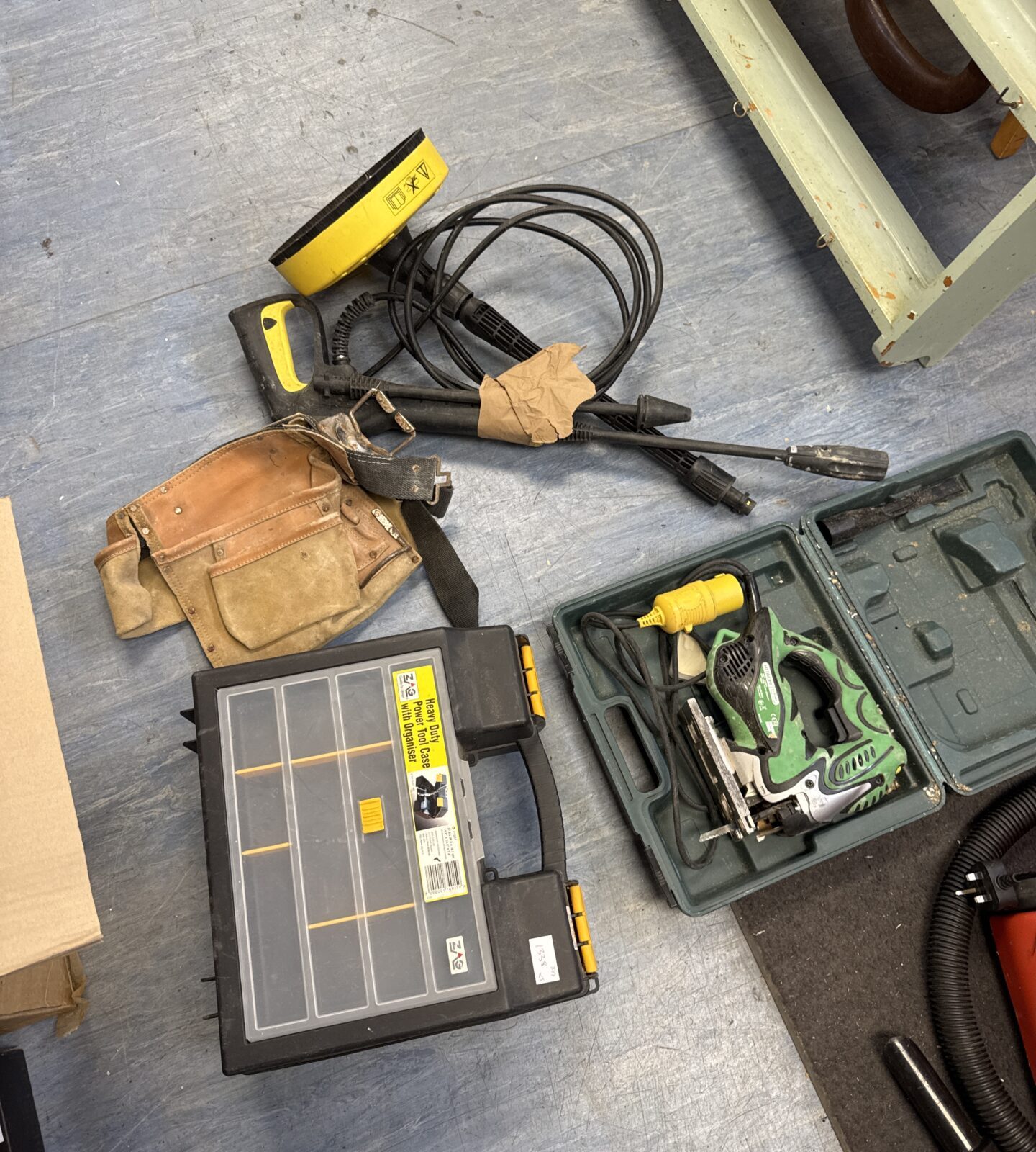 Bundle of karcher pressure washer attachments, a tool belt, hitachi 110v jigsaw (untested) & a tool case