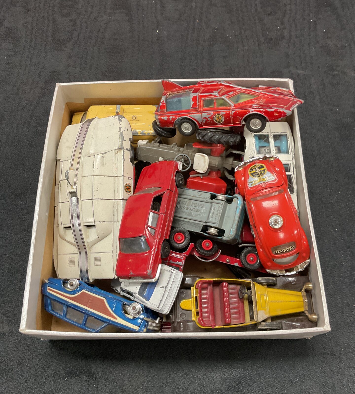 Box of vintage diecast vehicles including dinky spectrum cars