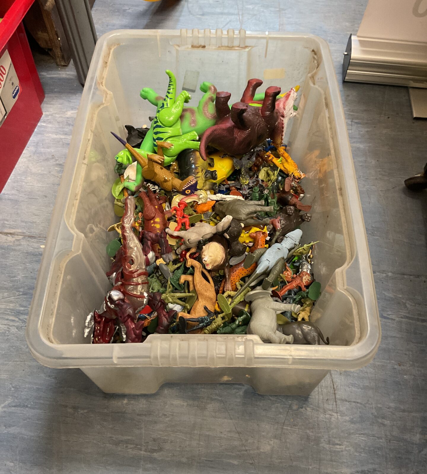 Box of animal toys and soldiers