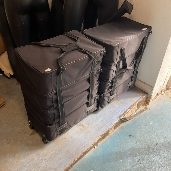 Two black wheeled storage cases/ shoe sample case