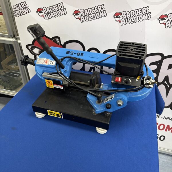 Blue BS-85 bandsaw on a table, workshop tool.