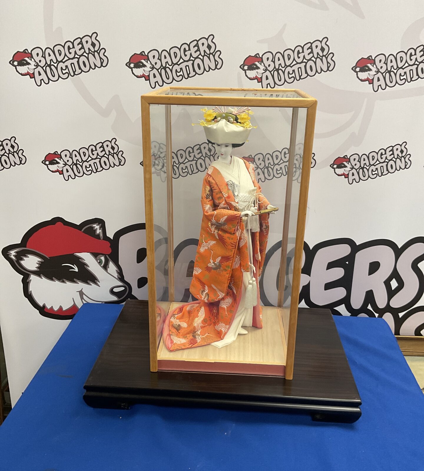 Japanese porcelain Geisha doll in case on wood plinth