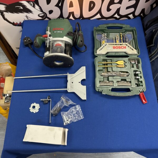 Bosch Pof 1200 AE router with accessories and drill bit set.