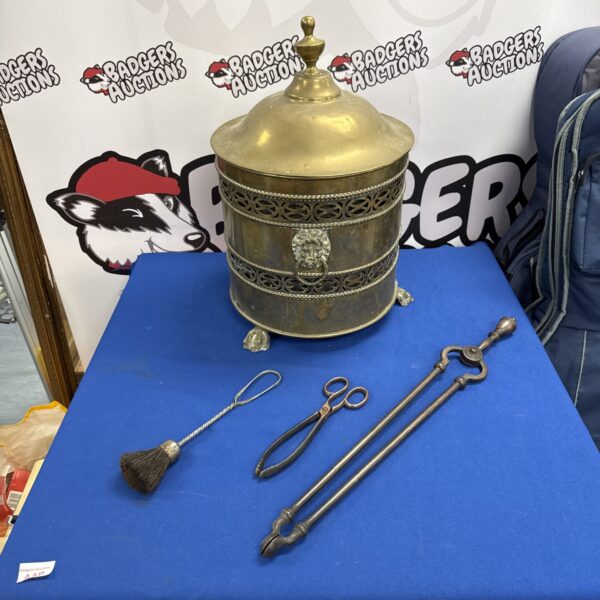 Vintage brass fireside coal bucket with lions head & claw foot detailing, two pairs of tongs & a brush
