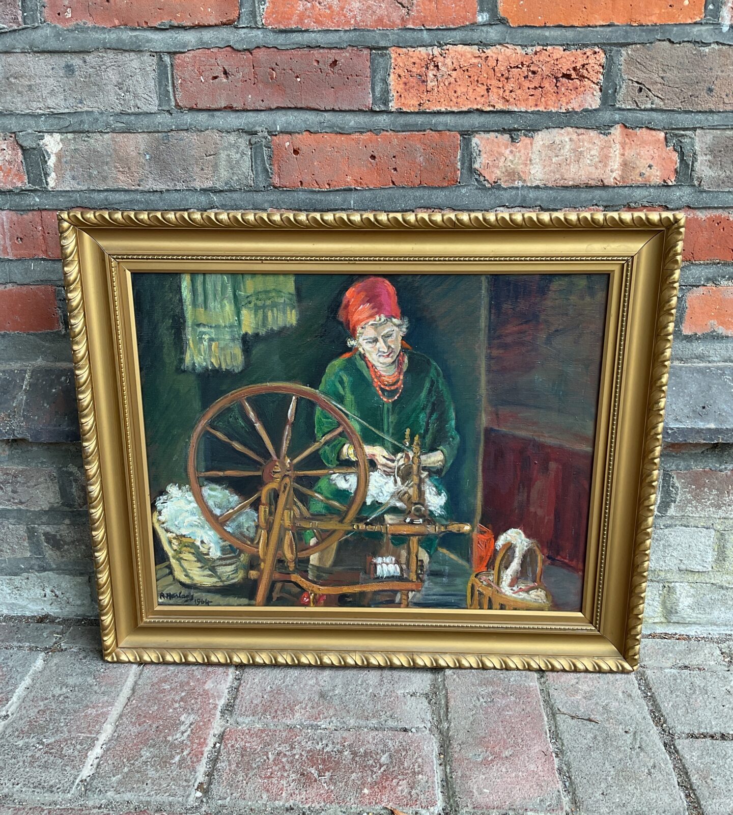 R harland signed oil painting of a lady working a spinning wheel