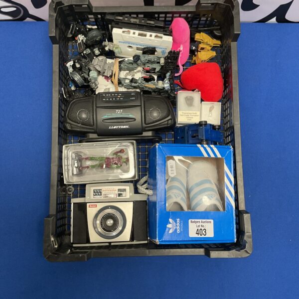 Box of mixed collectables and other items inc addidas size 3y,  triceratops and raptors tooth, kodak camera and transformer's