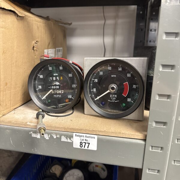 Pair of vintage Smith speedometer and RPM gauges for classic cars.