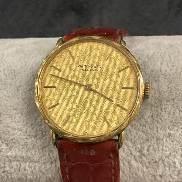 Vintage Raymond Weil Geneve watch with gold dial and case.
