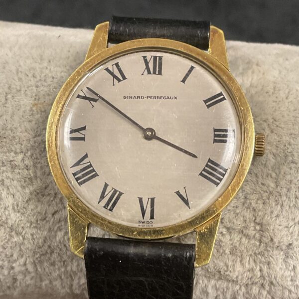 Vintage Girard Perregaux wristwatch with gold case and dial.