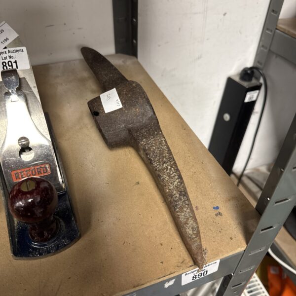 Vintage pick axe head showing wear and patina.