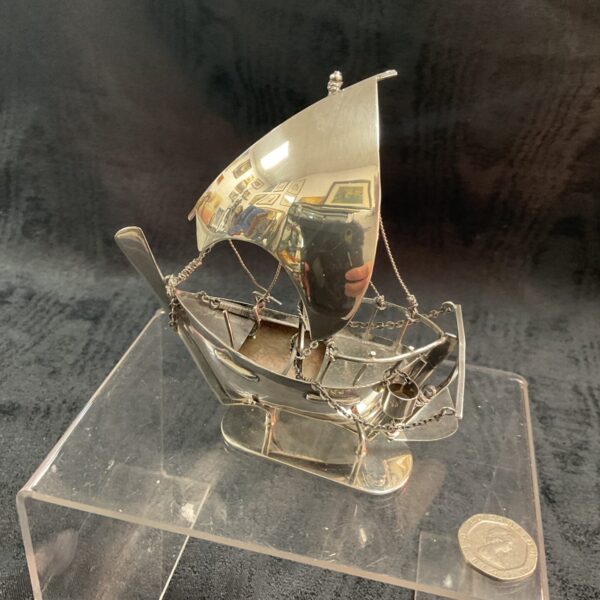 Detailed sterling silver sailing ship, nautical collectible.