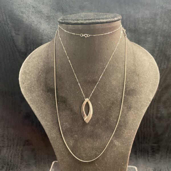 Two silver chain necklaces one with crossover pendant