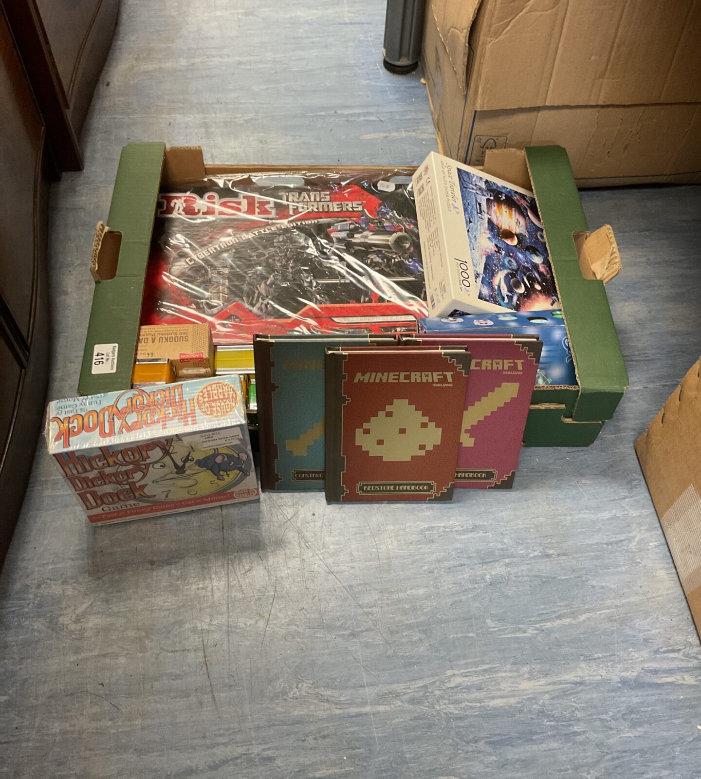 Box of mixed games and collectables inc mincraft handbooks, board games and puzzle