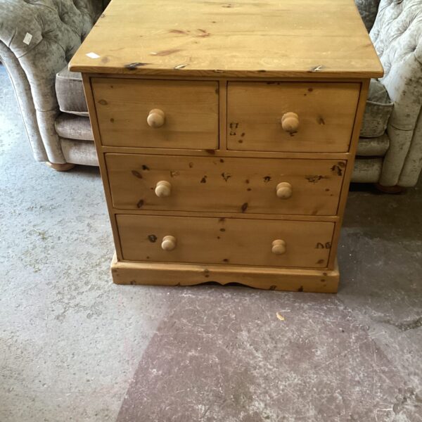 Front view of a vintage pine chest of drawers.
