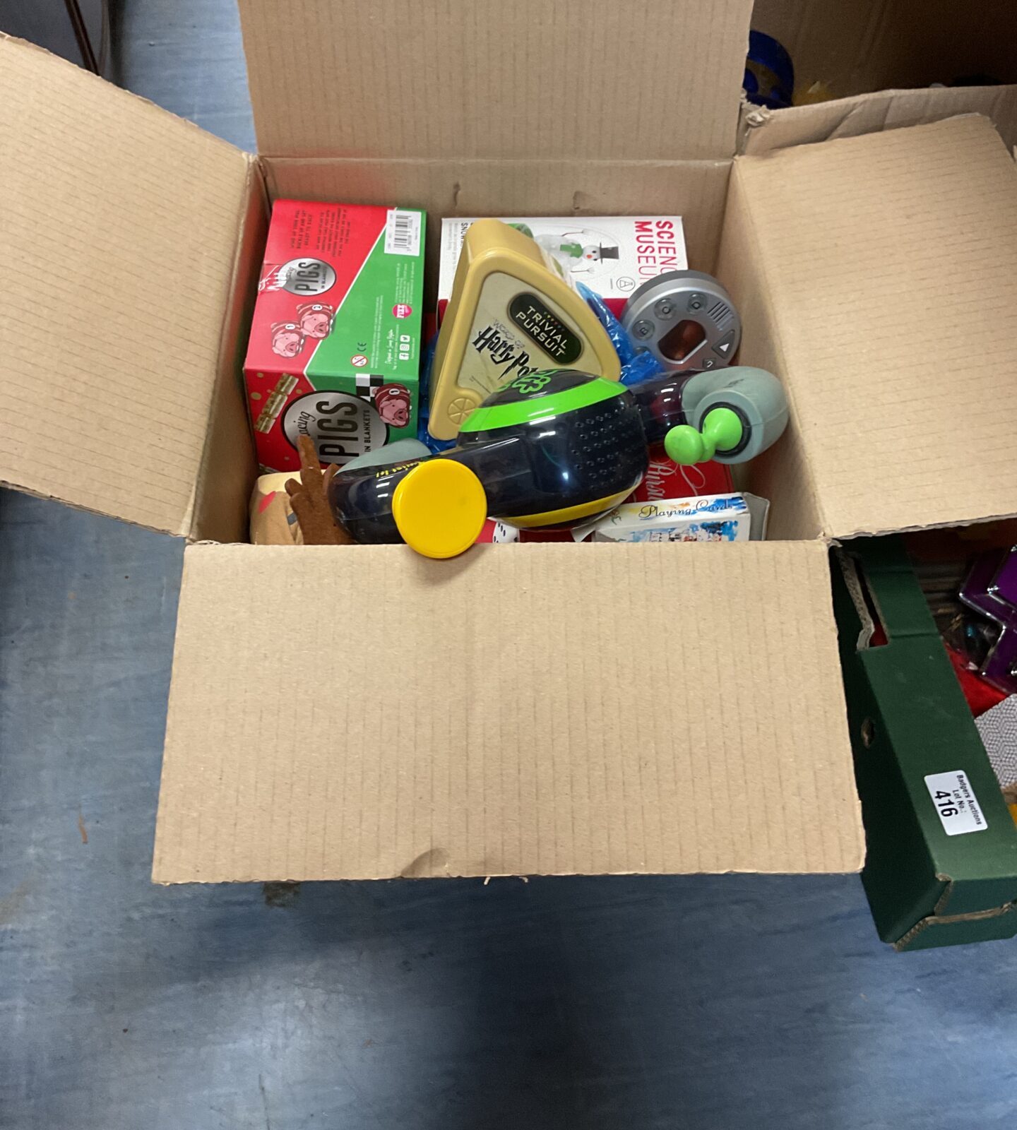 Box full of mixed games and toys