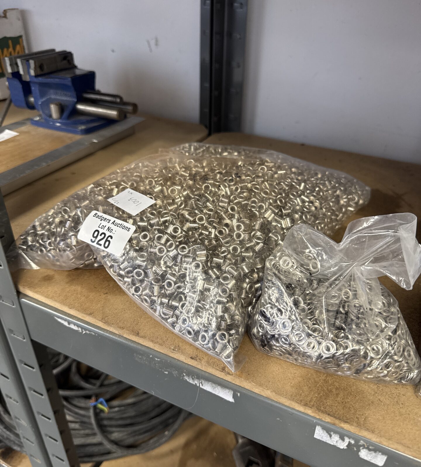 Two sealed bags of small fabric eyelets