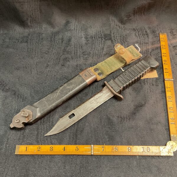 Vietnam survival knife with scabbard and sharpening stone.