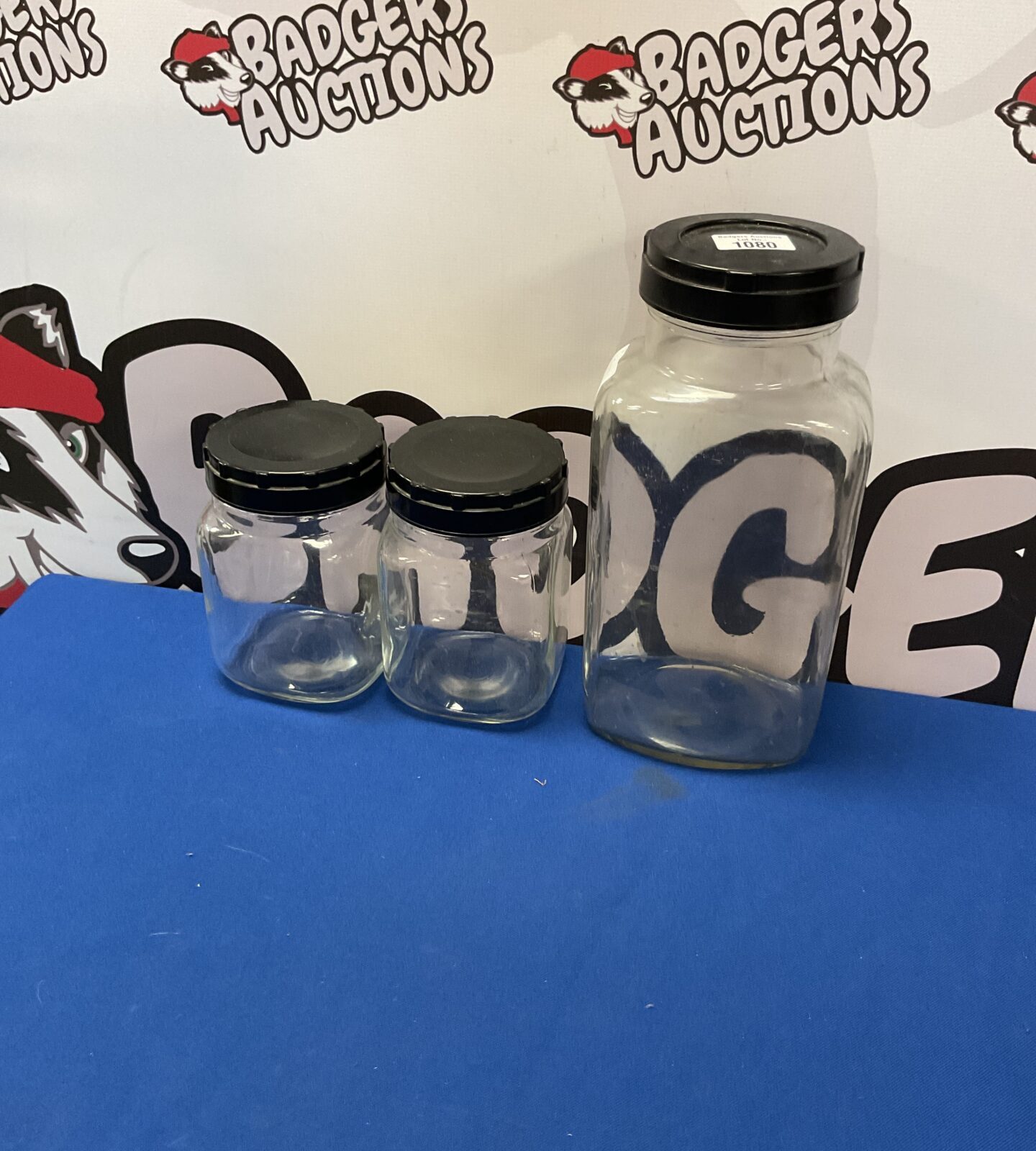 Three glass storage jars