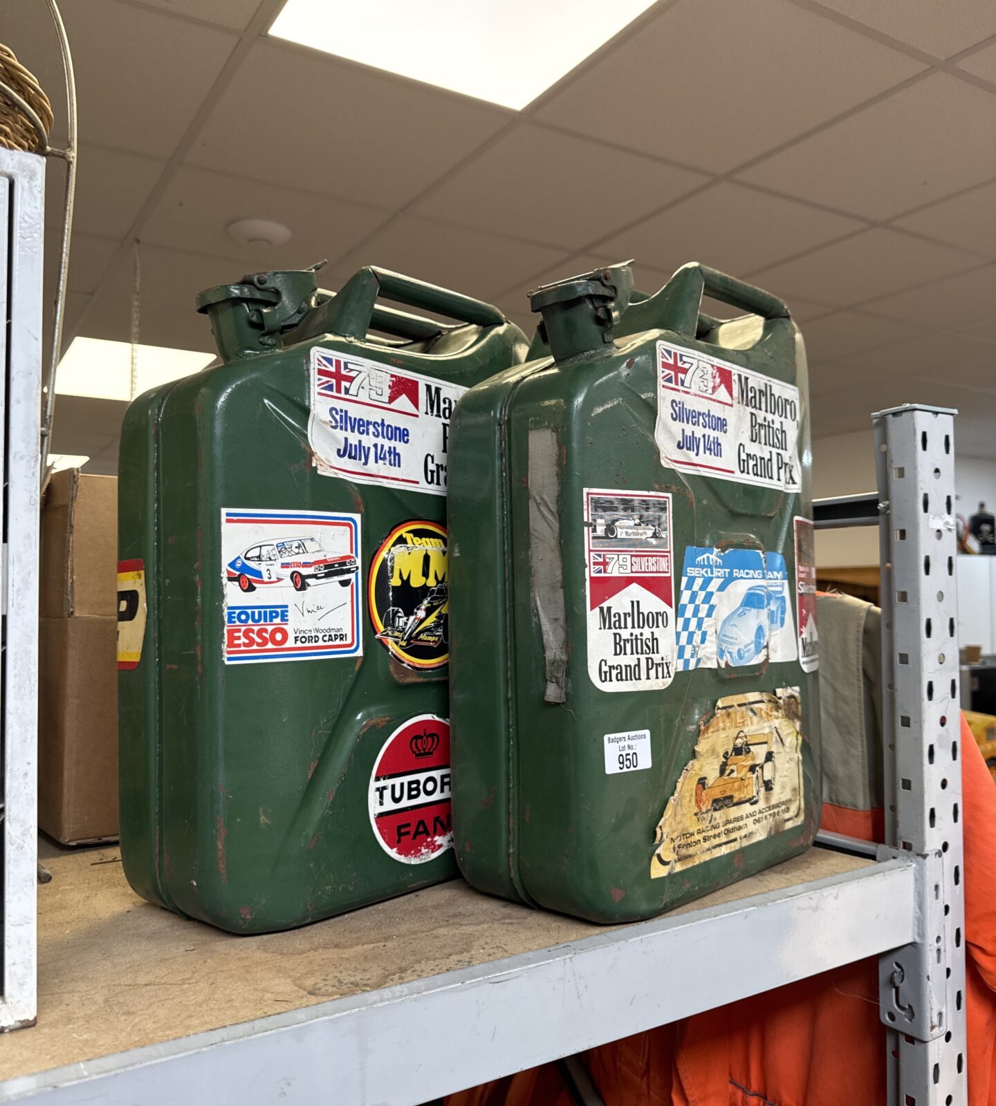 Two Jerry cans with motoring stickers