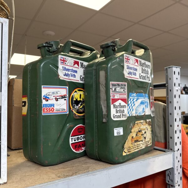Two Jerry cans with motoring stickers