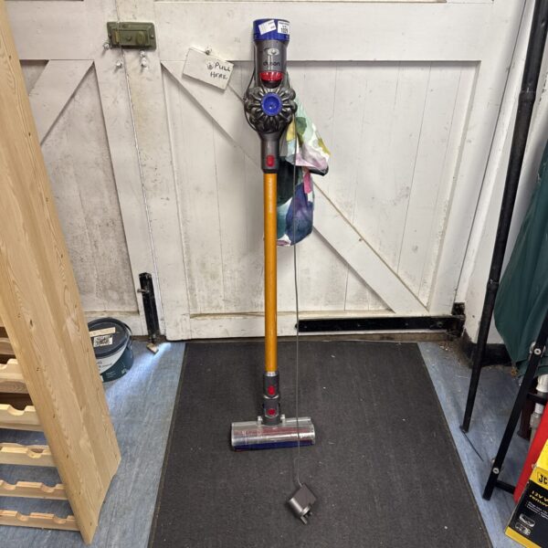 Dyson V6 Absolute cordless vacuum cleaner with attachments.