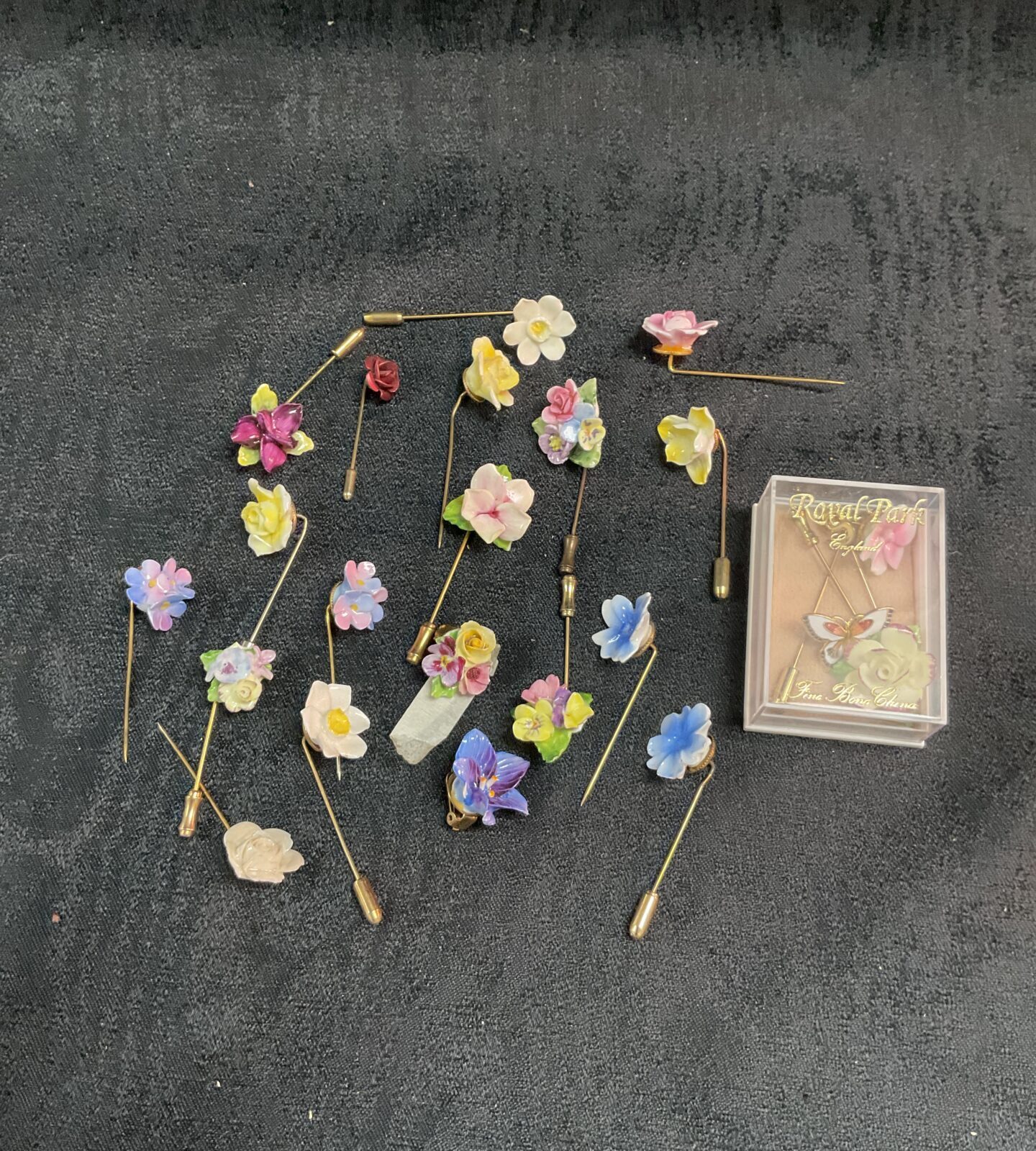 Twenty Floral stick pins and two earrings