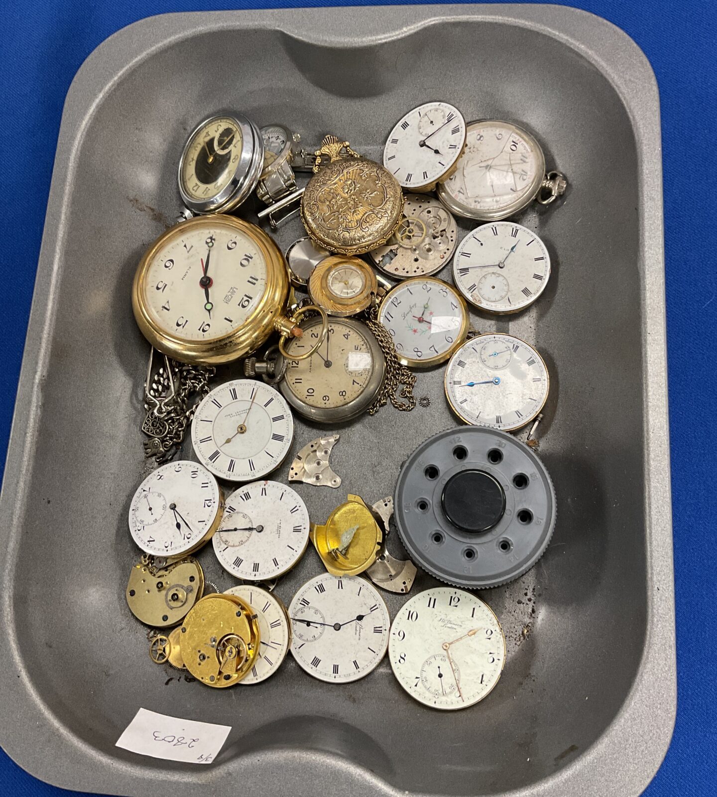 tray of watches and watch parts