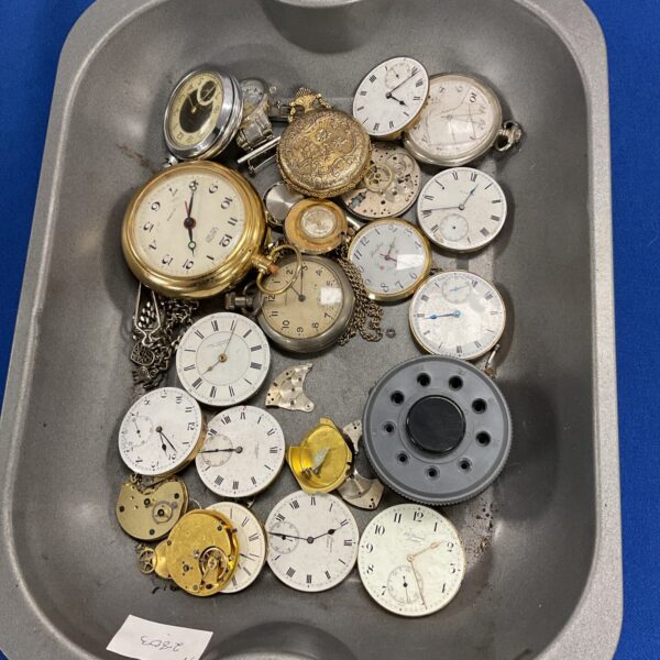 tray of watches and watch parts