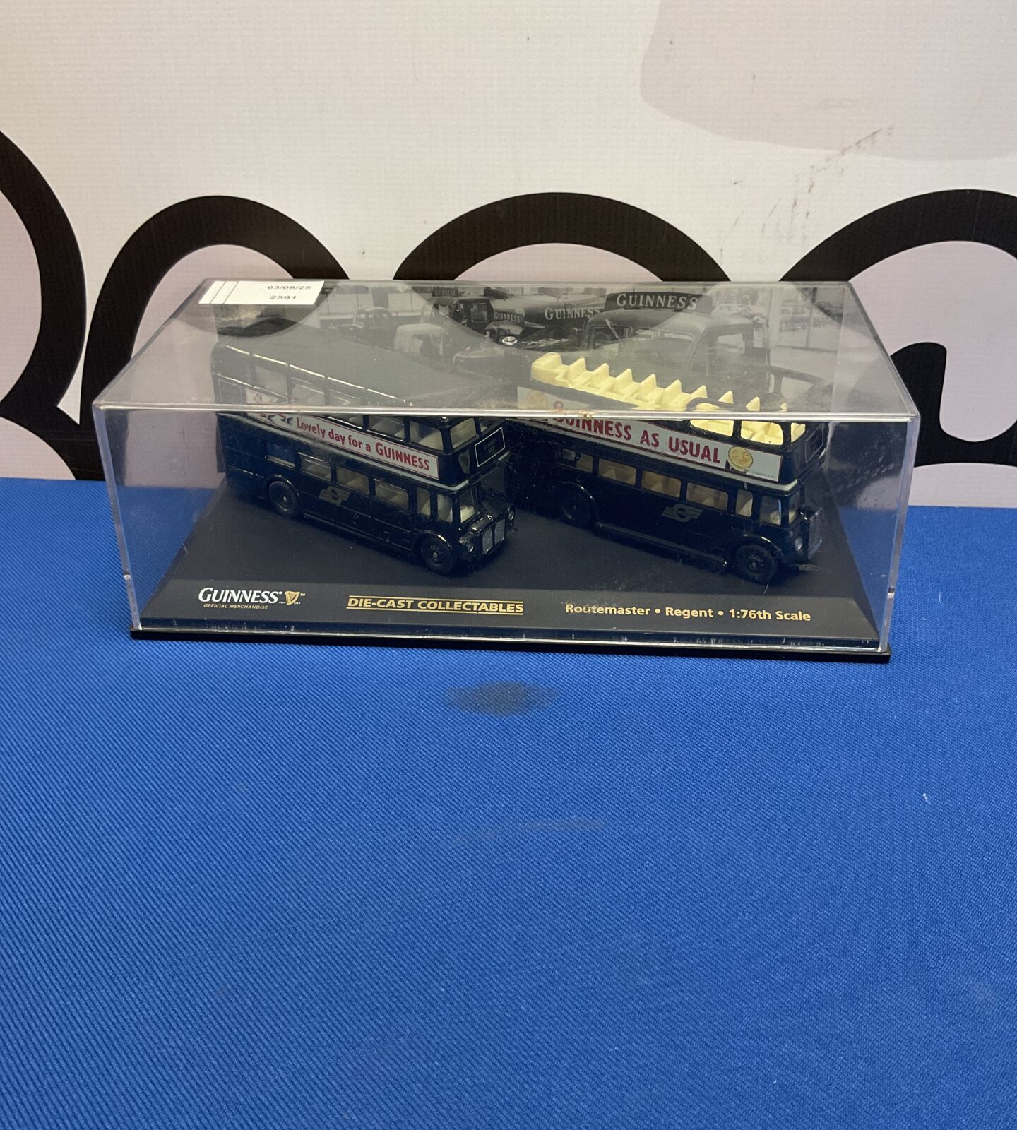 Two oxford diecast guinness collectable busses in display case