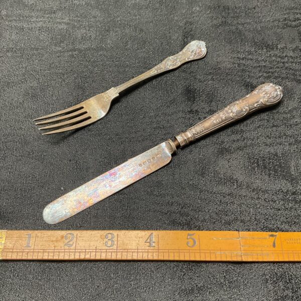 Antique Victorian silver knife and fork set with hallmarked detailing.