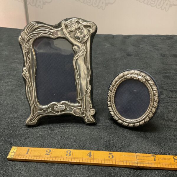Antique silver Art Nouveau picture frame with floral details.