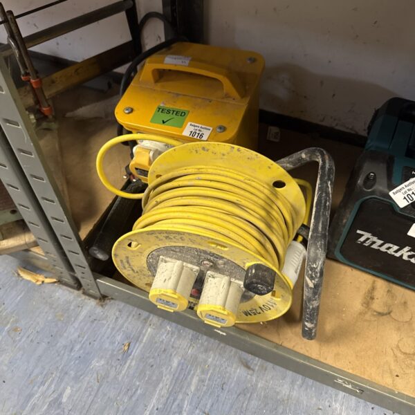 Yellow 110v transformer extension reel for site power.