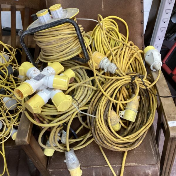 Large lot of yellow 110v power cables and connectors.